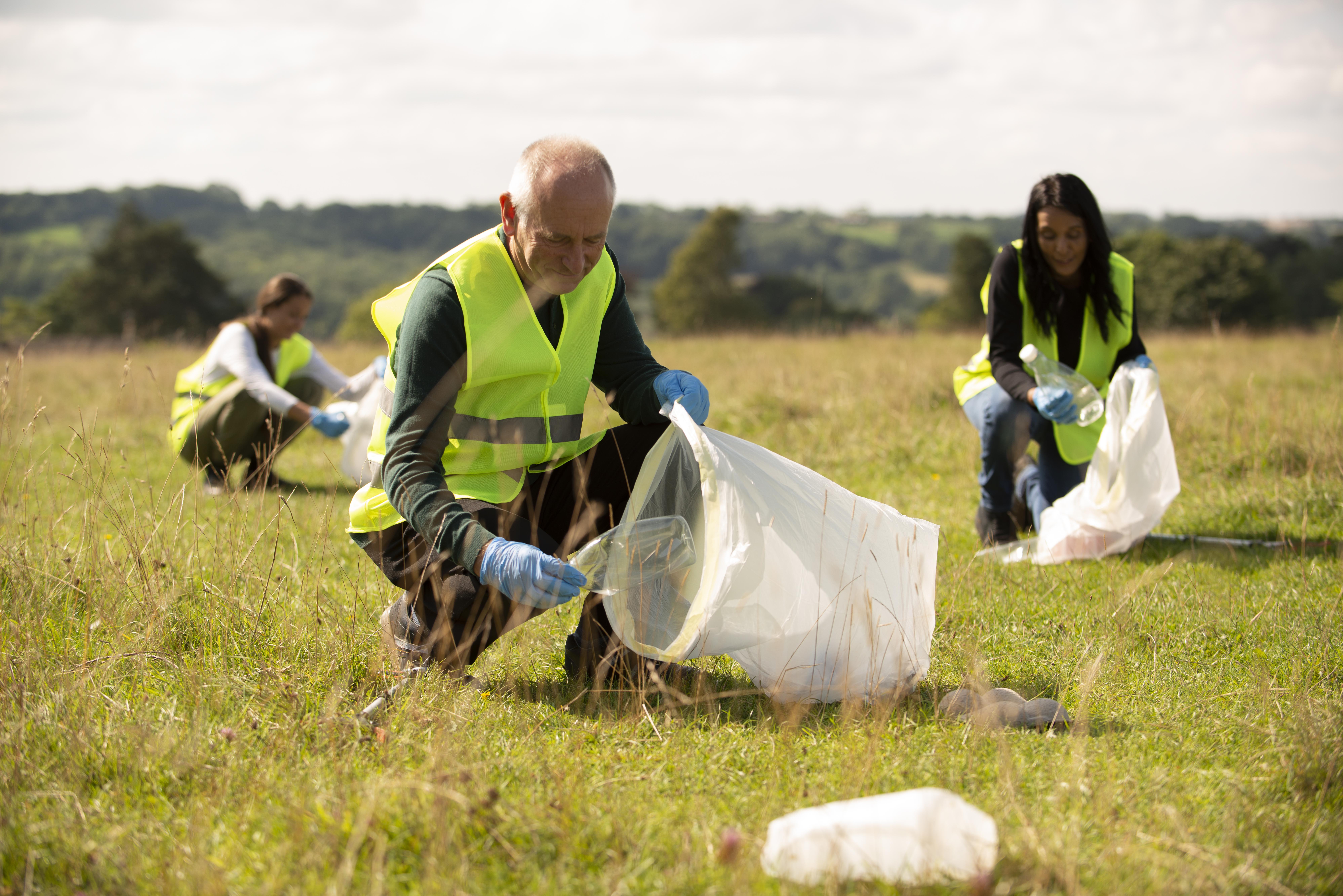 people-doing-community-service-by-collecting-trash-outdoors